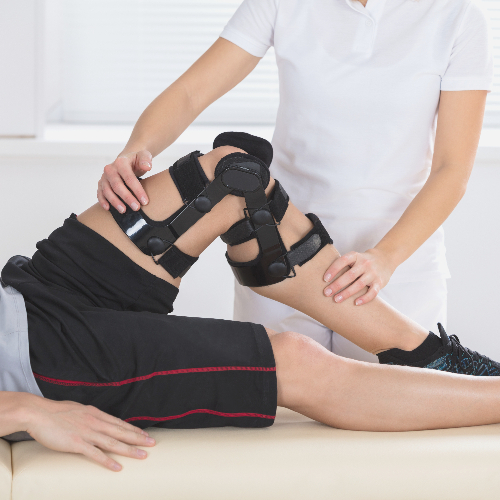 fysiotherapie doet een patiënt met kniepijn een kniebrace om